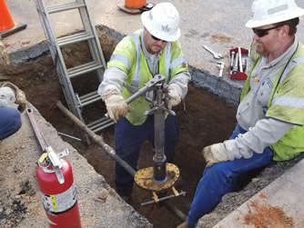 Workers digging hole